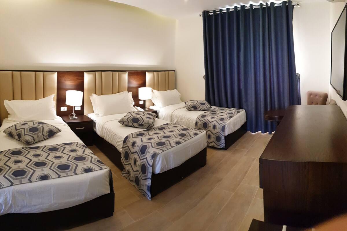 deluxe triple room | 1 bedroom, pillow-top beds, minibar, in-room safe