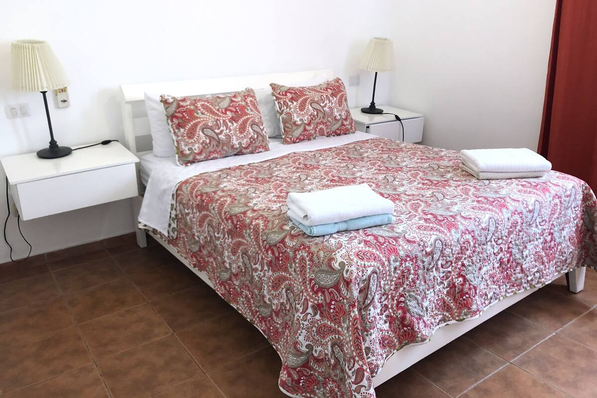 Junior Apartment, 1 Bedroom, Pool View, Ground Floor | In-room safe, desk, laptop workspace, iron/ironing board