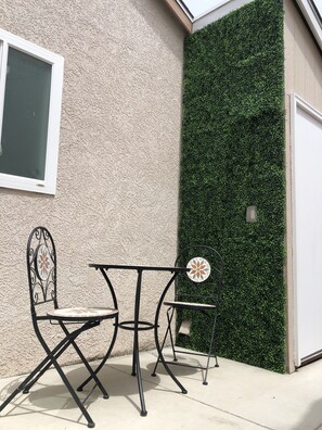 Relax in the outdoor seating area with a table and two chairs.
