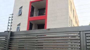 Un edificio de varios pisos con un diseño moderno, que destaca por su llamativo esquema de color rojo y blanco.