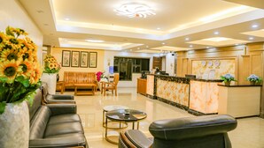 A hotel lobby with a reception desk, seating area, and decorative elements. - 456 Hotel (Baguio)