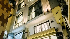 A building with multiple windows, a visible entrance, and a sign indicating the number 9. - Eighty8 Home - Hostel (Hanoi)