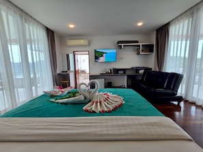 A hotel room with a bed, a TV, a desk, and a chair. - PP Mountain Beach Resort  (Ko Phi Phi)