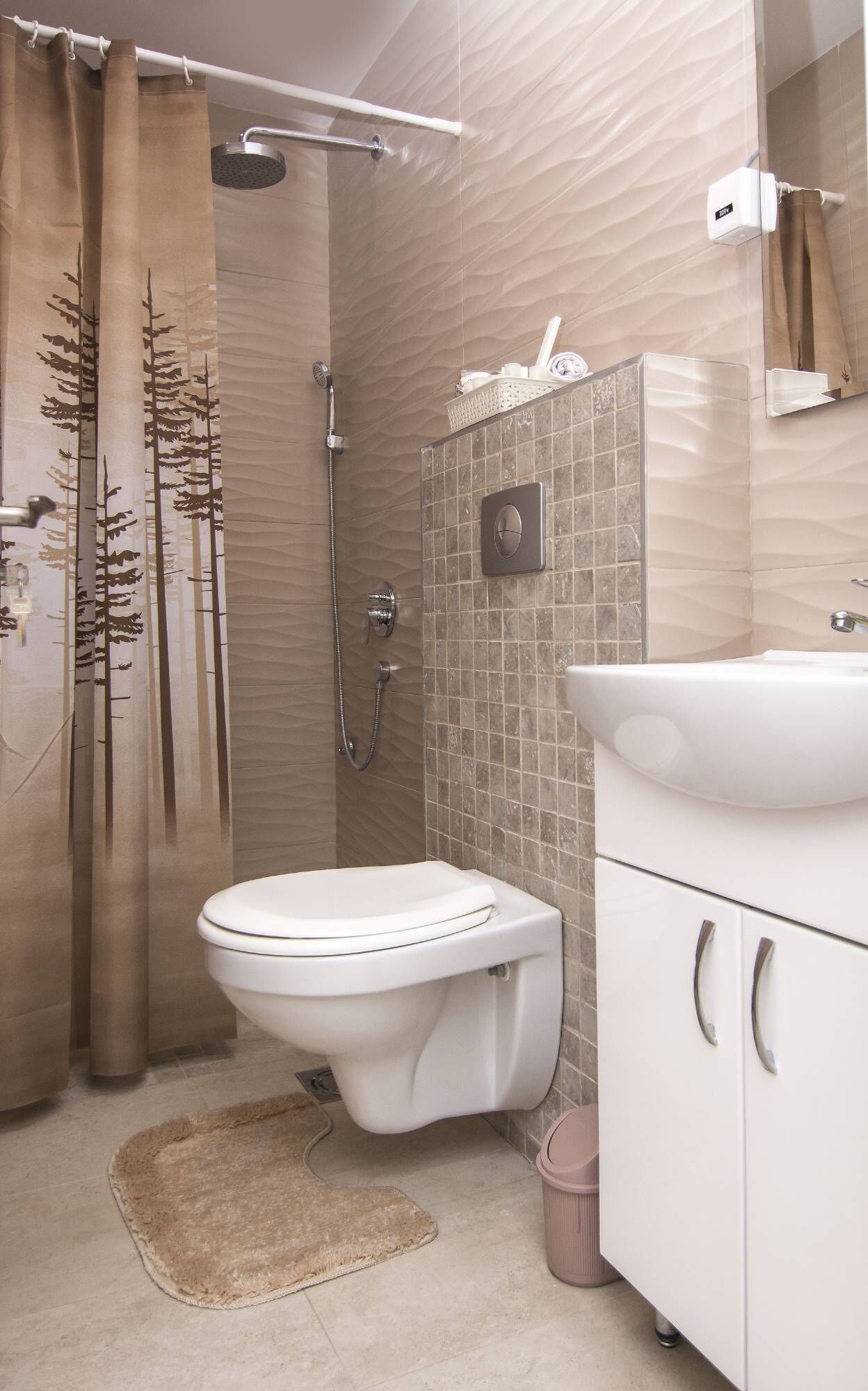A bathroom with a shower, toilet, and sink.