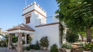 A white building with a small tower, a covered patio, and potted plants. - Villa del Manzano, Complete villa with pool just 15 minutes from Seville (Villanueva del Ariscal)
