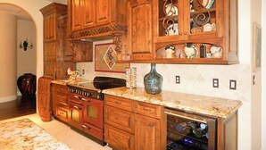 A kitchen with wooden cabinets, a built-in oven, and a dishwasher.