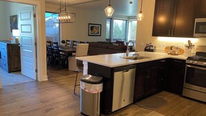 A modern kitchen with a central island, stainless steel appliances, and pendant lighting. - Spacious New Condo - Beautiful Views in the Heart of  Dillon. License# 651848101 (Dillon)