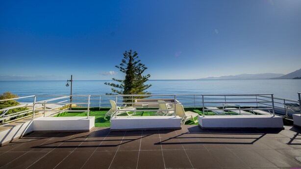 A terrace with white lounge chairs and a view of the sea. - Villa Francesca Sicily 8, Apartment in Villa on the sea (casteldaccia)