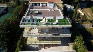 A two-story residential building with a rooftop terrace featuring a swimming pool, lounge chairs, and a covered patio area. - Villa Francesca Sicily 23, Apartment in Villa on the sea (Casteldaccia)