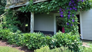 A house with a wooden balcony, potted plants, and a red awning. - Mountain-view House ~ Mins To Middlebury, Flex Cancellation Policy (Cornwall)