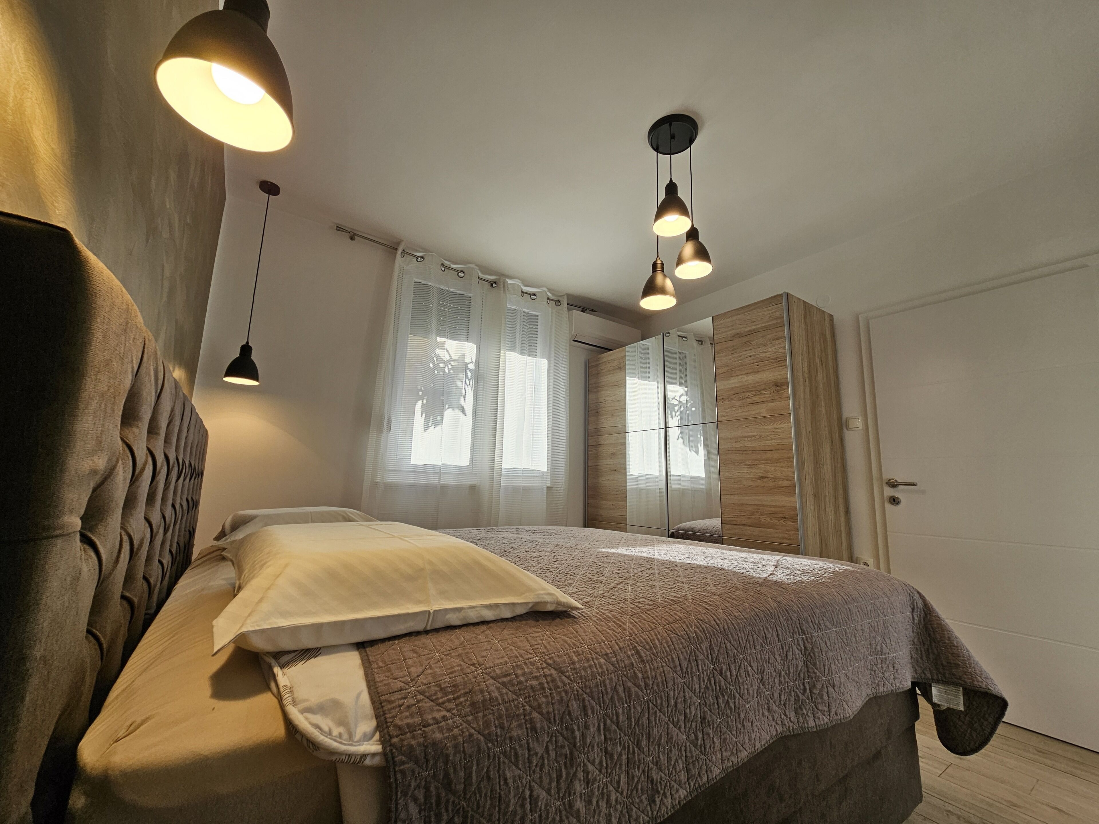 Un dormitorio con cama, armario y puerta.