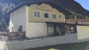 Ein zweistöckiges Gebäude mit einem Schild, auf dem 'Haus Schrankenblick' steht.