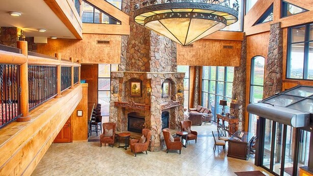 A spacious lobby with a high ceiling, stone pillars, a fireplace, and comfortable seating areas. - Rare 1BR for 4 at Westgate Park City. Ski-In/Ski-Out. Walk to Gondola. (Park City)