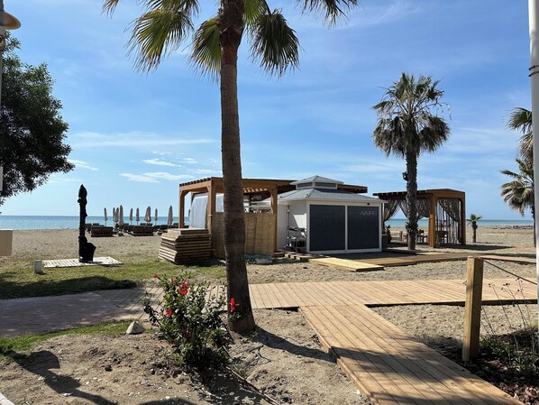 On the beach, sun loungers, beach towels