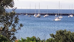 A marina with several sailboats docked at a pier.