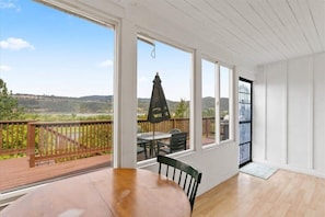 Enjoy a scenic view from the room's large window, which looks out onto hills and a body of water.