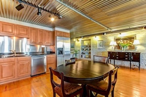 Enjoy meals at the large dining table surrounded by comfortable chairs.