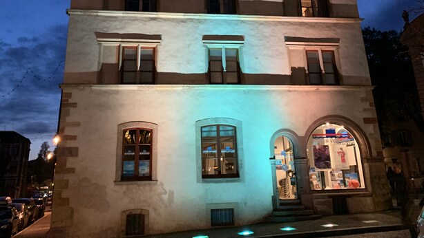 A historic building with multiple windows and a central entrance.