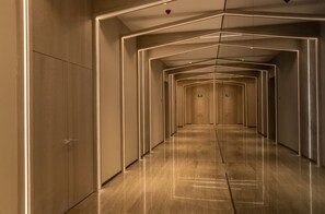 A modern hotel corridor with a geometric light design on the walls and floor. - Le Ville Residence (Xi'an)