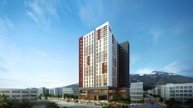 A modern high-rise hotel with multiple floors, large windows, and a prominent entrance. - Dongdaemun PR. Mondern Studio (Seoul)