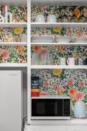 Enjoy cooking and brewing in this fully equipped kitchen with a microwave and coffee maker.