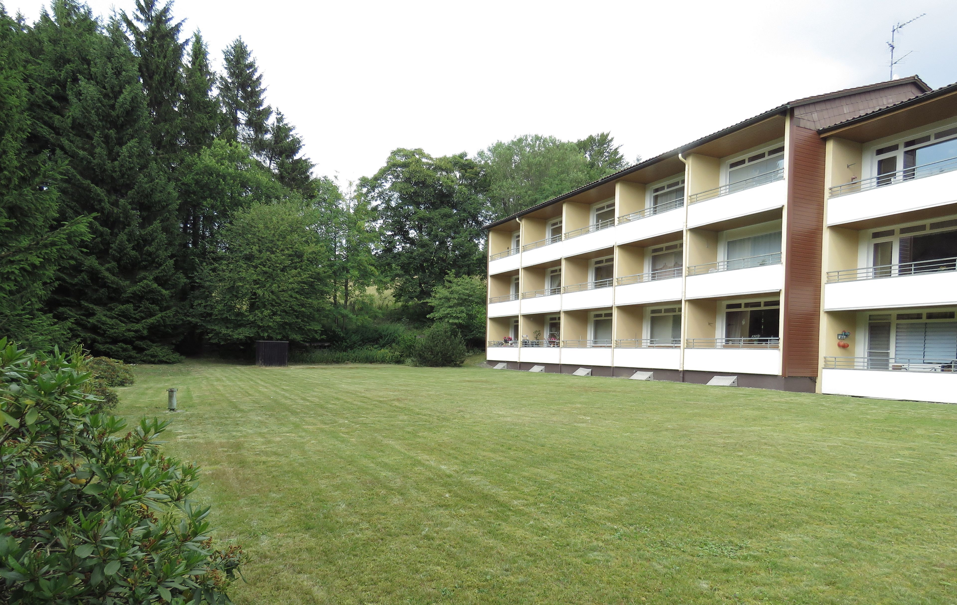 A multi-story hotel with a flat roof and balconies on each floor.
