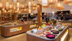A buffet area with various food items and a modern interior design. - Oakwood Ha Long (Bai Chay)