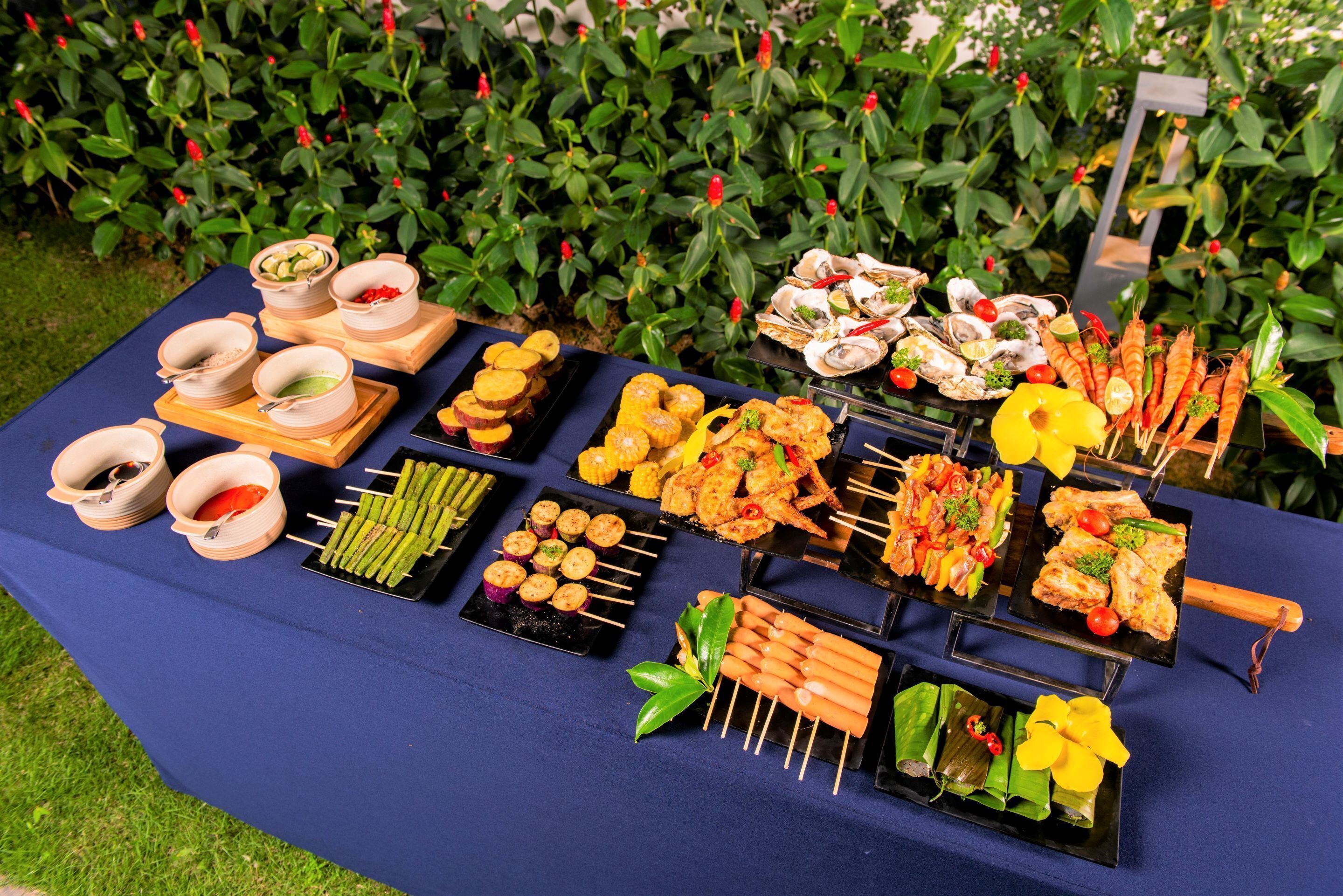 A buffet table with various food items and bowls.
