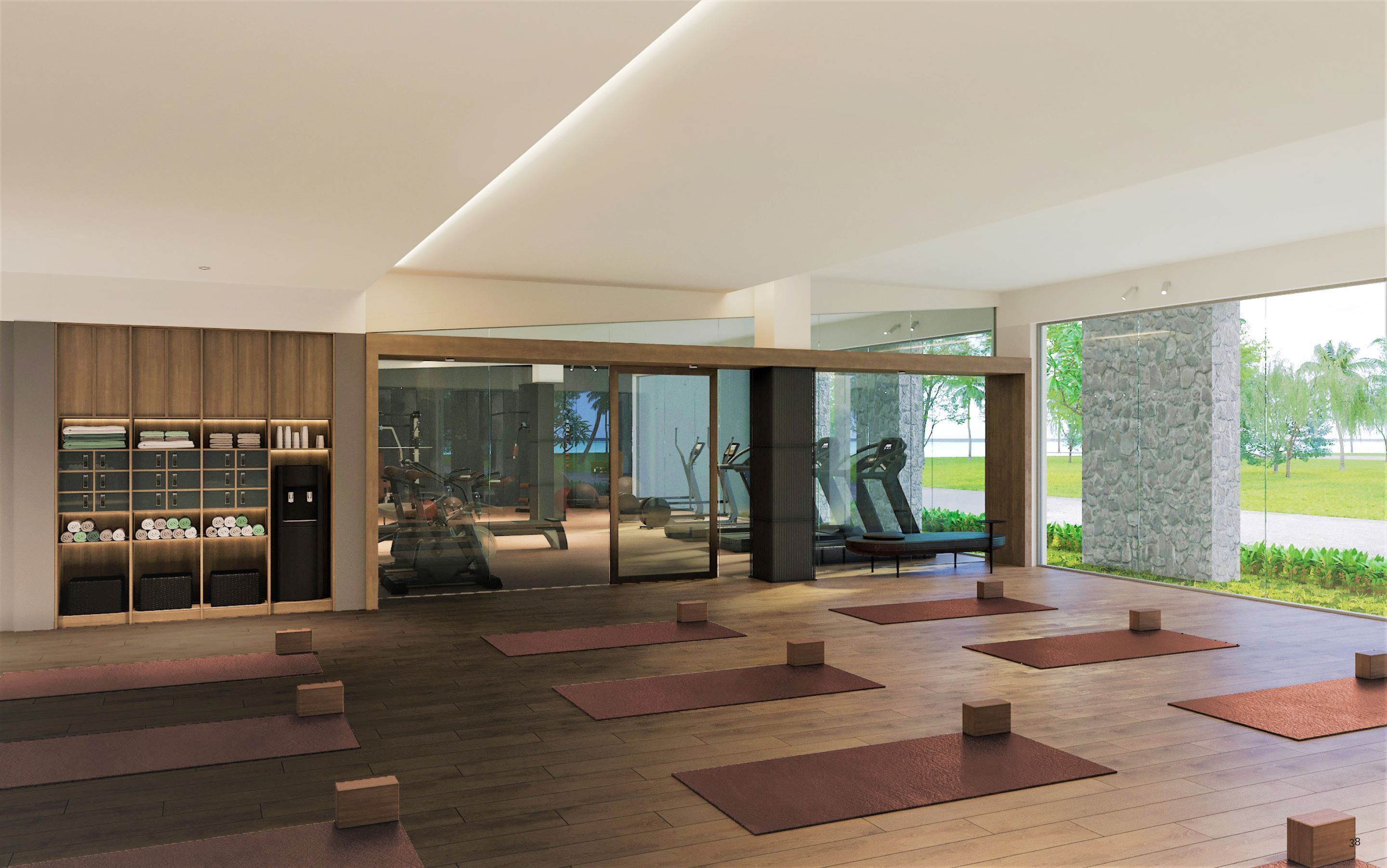 A modern gym with exercise equipment, wooden flooring, and a glass wall offering a view of the outdoors.
