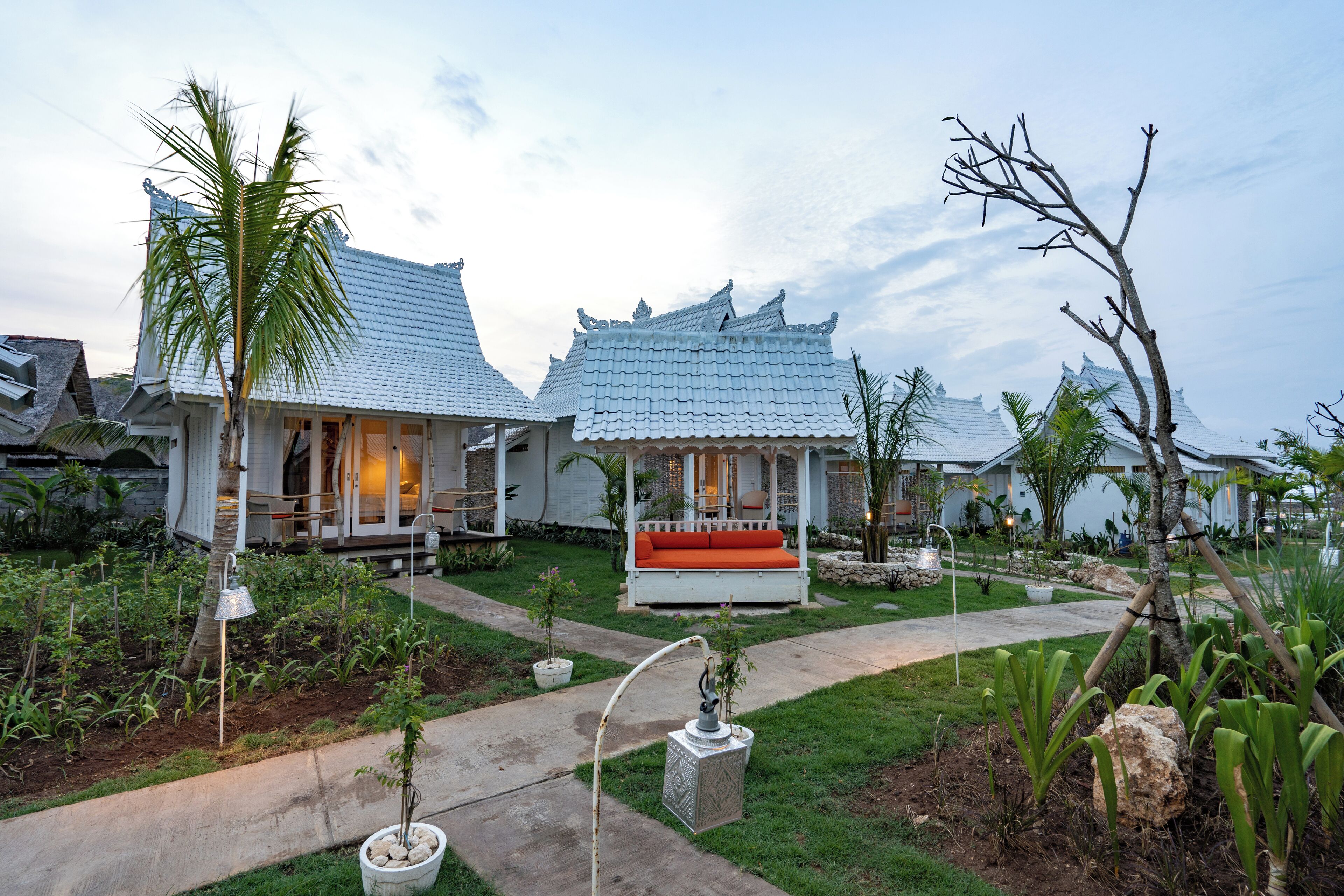 A traditional-style building with a covered porch and a small garden area.