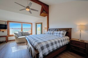 A bedroom with a bed, a desk, a chair, a TV, and a window with a view. - Hot Tub & Moat Mtn Views: North Conway Townhouse (North Conway)