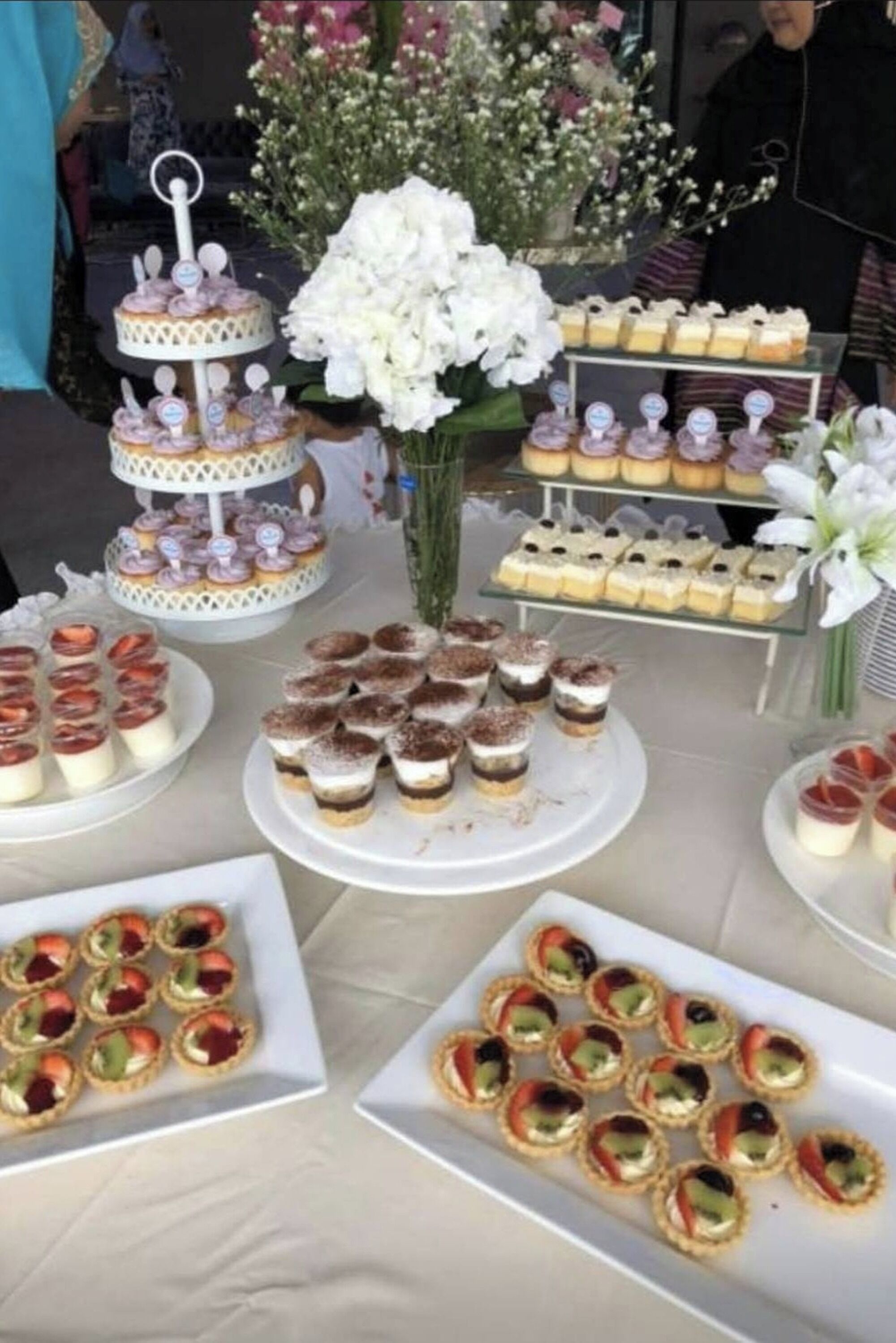 A buffet table with various desserts and pastries.