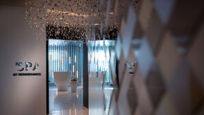 A modern spa interior with a minimalist design, featuring a large bathtub and a reception area with a sign reading "SPA AT RENAISSANCE". - Renaissance Nanning Hotel (Nanning)