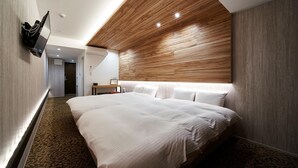 A modern hotel room with a large bed, a wooden accent wall, and a flat-screen TV mounted on the wall. - Carta Hotel KyotoBettei (Kyoto)