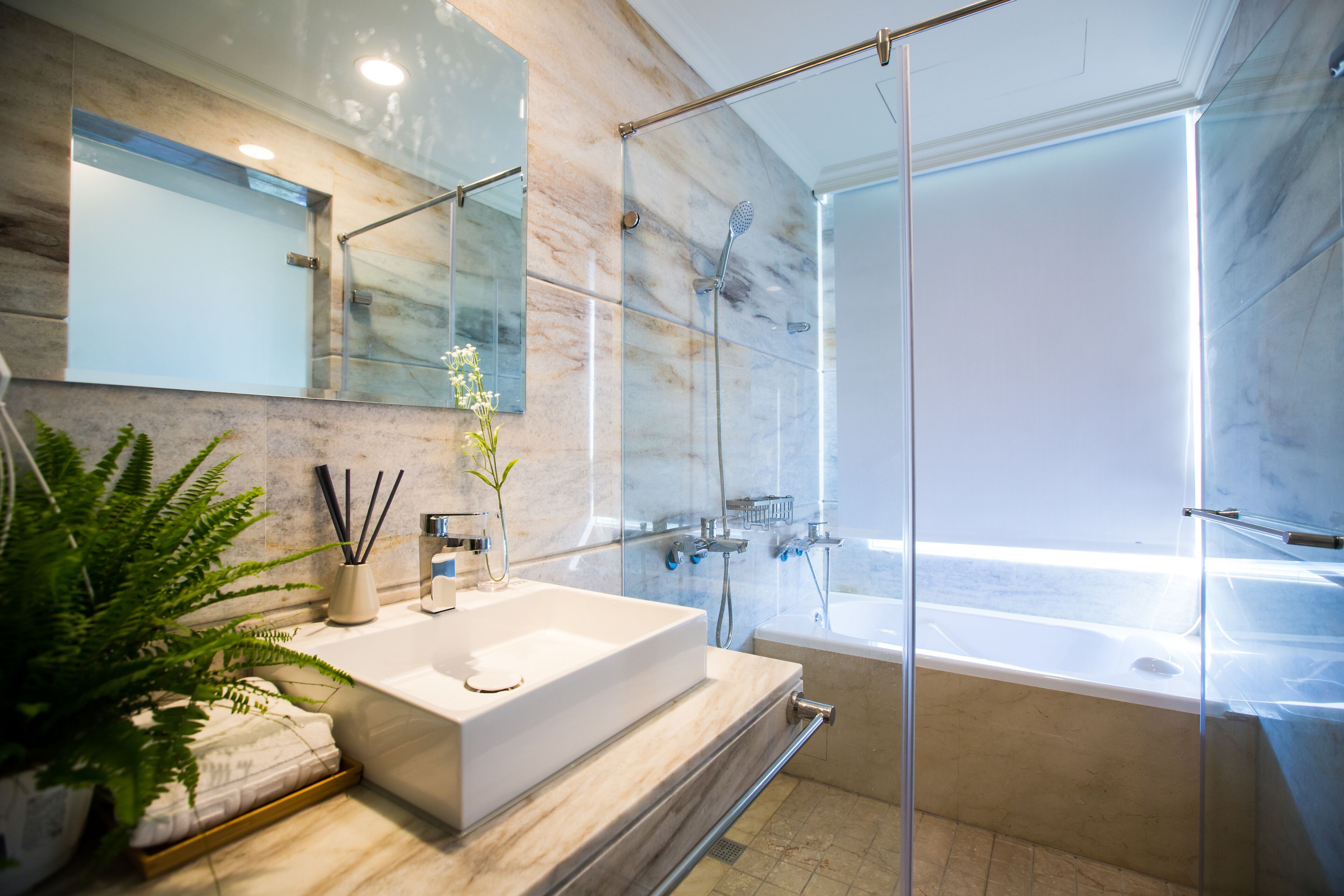 deluxe quadruple room | bathroom | shower, free toiletries, hair dryer, slippers