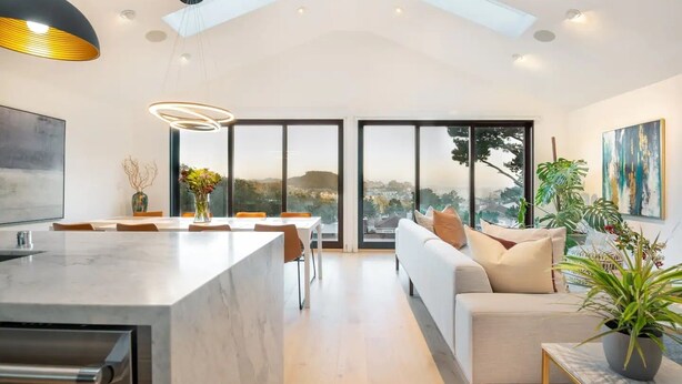 A modern living space with a kitchen, dining area, and seating area with a view of the city. - Exceptional Hilltop Villa with Panoramic View (SF)