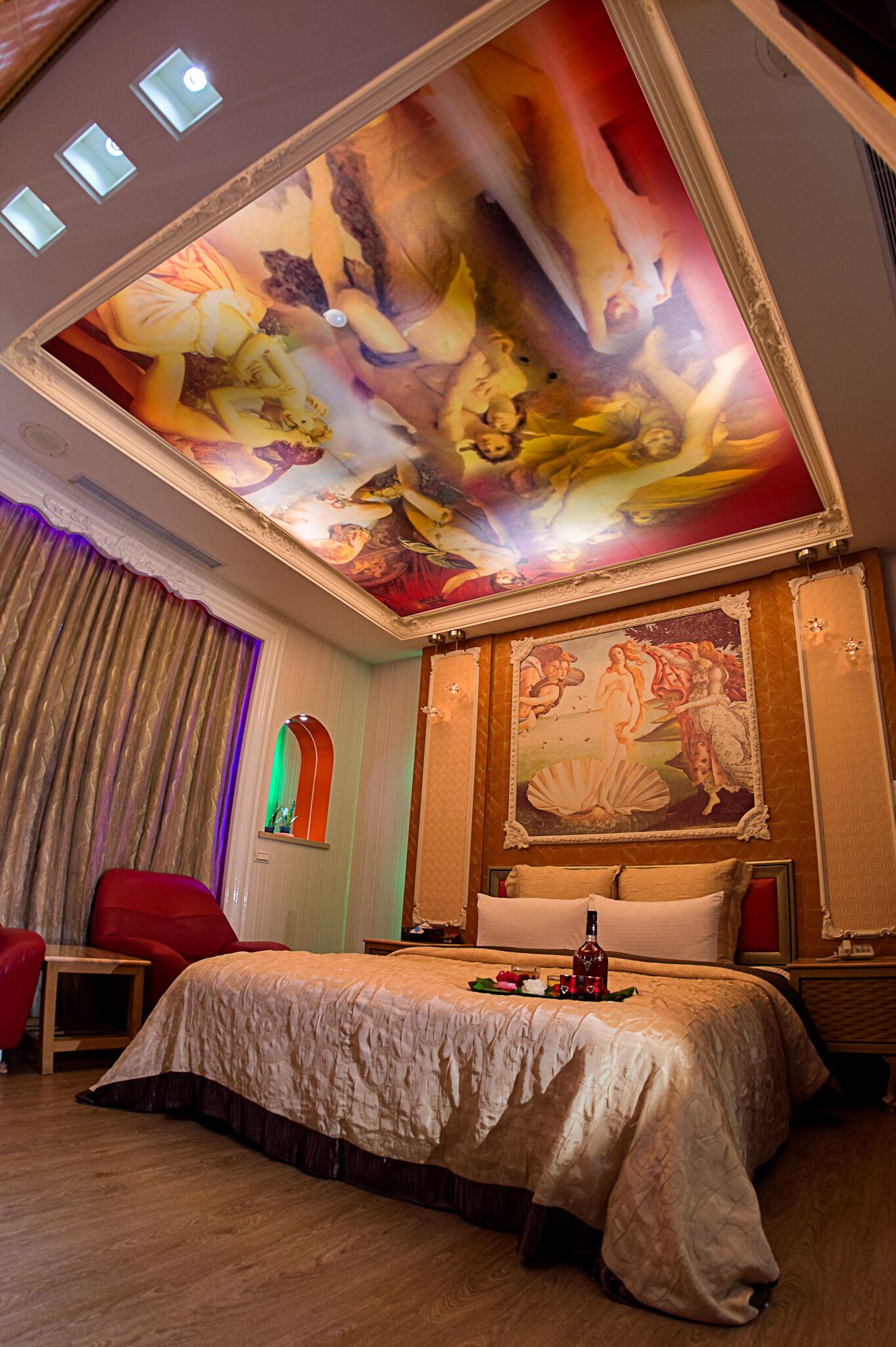 A luxurious hotel room with a large bed, a ceiling mural, and a classic decor style.