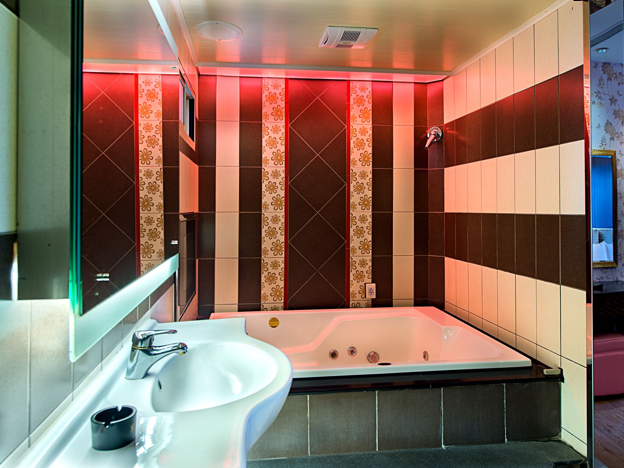 A modern bathroom with a large bathtub, a sink, and a shower.