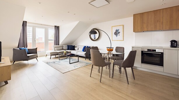 A modern apartment with a dining area, kitchen, and living room. - Staines City Centre by Charles Hope (Staines)