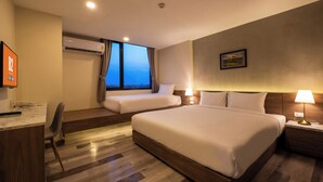 A hotel room with a large bed, a smaller bed, a desk with a phone, and a window with curtains. - B2 Korat Premier Hotel (Nakhon Ratchasima)