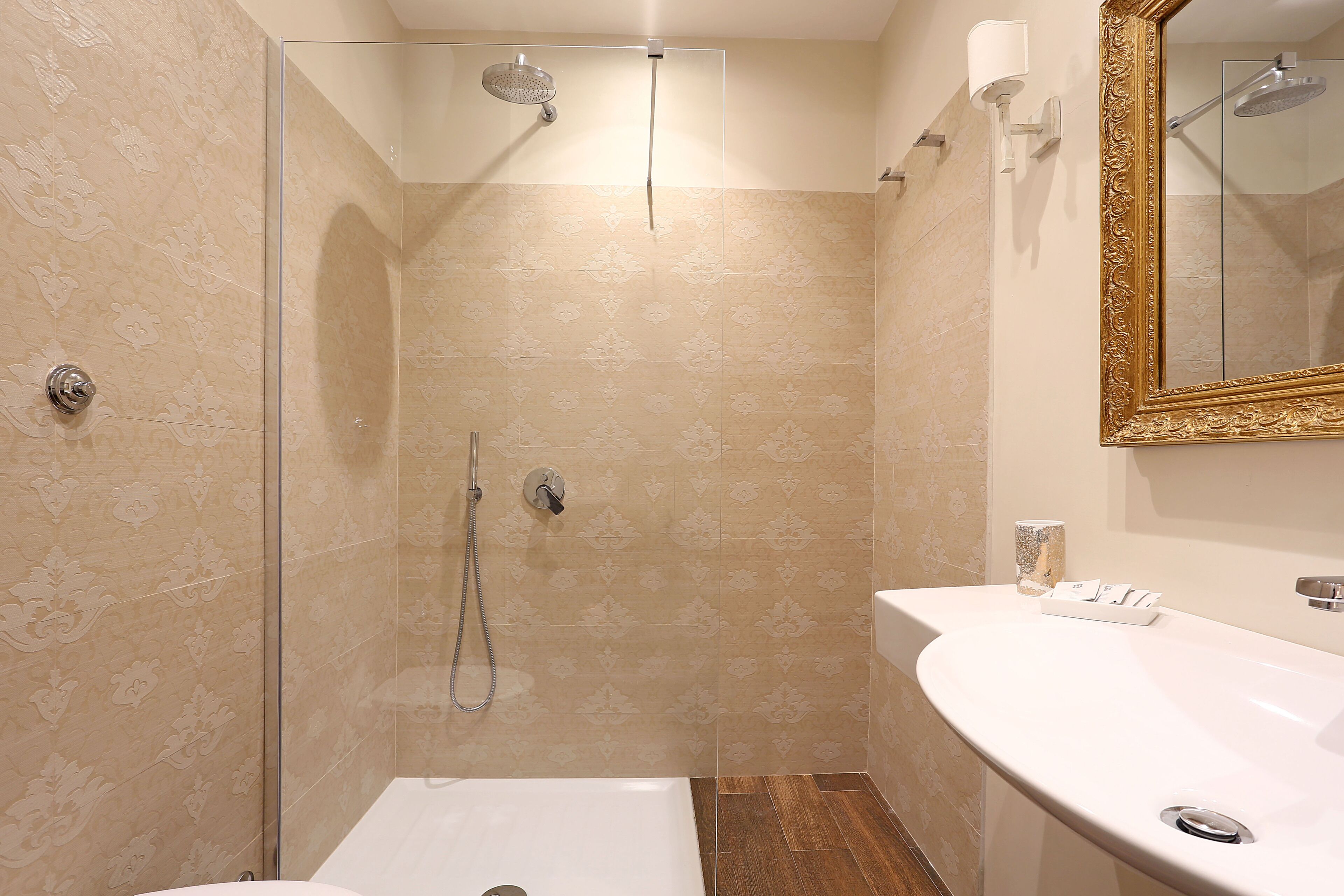 A bathroom with a shower, a sink, and a mirror.