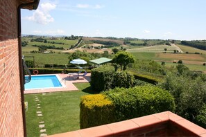 A pool area with a view of rolling hills and fields.