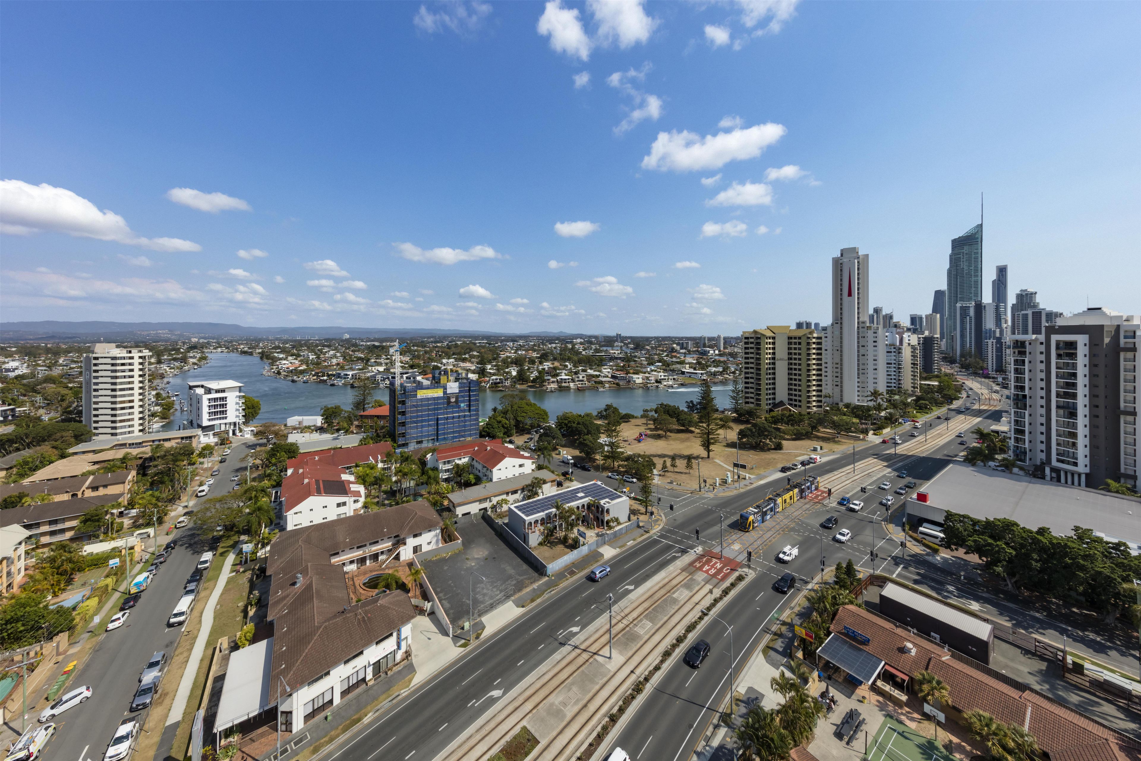 A cityscape with a mix of high-rise buildings, a river, and a highway.