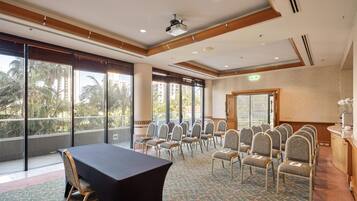 A conference room with a large table, chairs, and a projector.