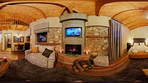 A cozy lounge area with a stone fireplace, a television mounted on the wall, and a comfortable seating arrangement. - Mylaon Boutique Hotel & Spa (Gortynia)