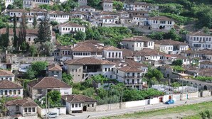 A densely packed hillside village with traditional architecture, narrow streets, and a mix of residential buildings. - Hotel Gorica (Berat)