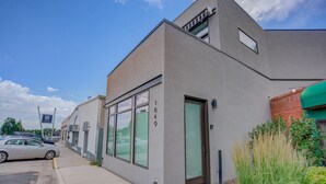 Un edificio moderno con techo plano, ventanas grandes y una puerta visible.