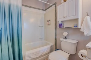 A bathroom with a bathtub, toilet, and a shower area. - Craft Brewery Perfection! Charming & Dog-friendly (Colorado Springs)