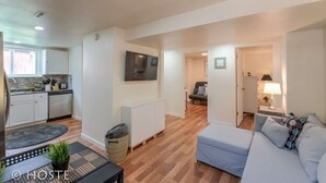 A modern apartment with a kitchen, living room, and dining area.