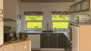 A modern kitchen with skylights, wooden cabinets, and a view of greenery outside. - Beautiful holiday home on Nordals, Vinkelbæk 40 (Nordborg)